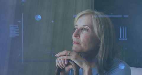 Mature woman contemplating future while visualizing data with blue hud overlay