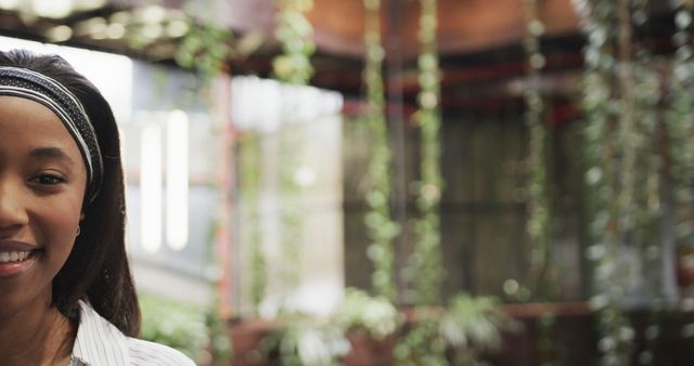 Smiling Woman Indoors with Natural Hanging Plants in Background - Download Free Stock Images Pikwizard.com