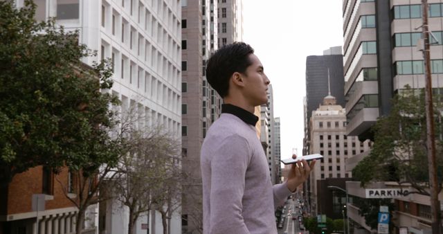 Businessman Walking in Urban Area Holding Smartphone - Download Free Stock Images Pikwizard.com