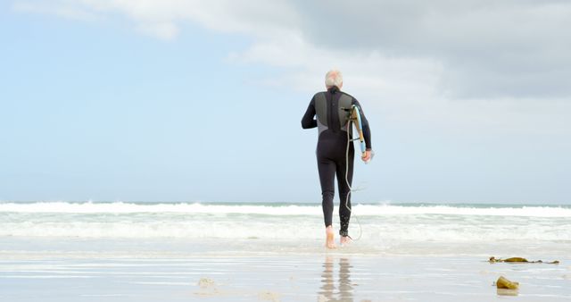 Senior Surfer Walking Towards Ocean with Surfboard - Download Free Stock Images Pikwizard.com
