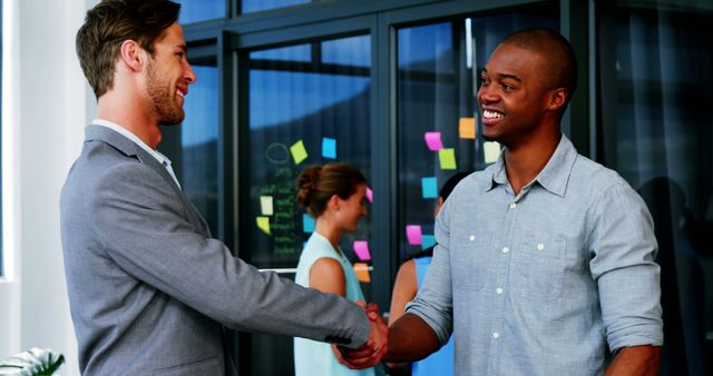 Multiracial Colleagues Shaking Hands at Office - Download Free Stock Images Pikwizard.com