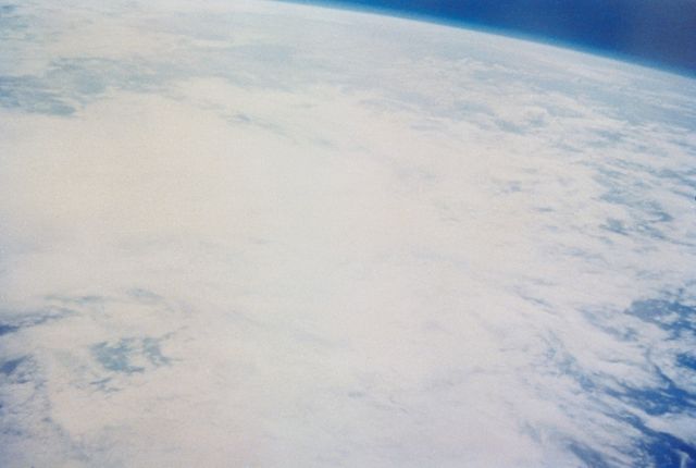 This image captures Earth from space during the Mercury-Atlas 7 mission, piloted by astronaut Scott Carpenter in 1962. The photo, taken with a hand-held camera, shows a beautiful view of Earth’s atmospheric layers and cloud formations. Suitable for use in educational materials, publications relating to space exploration history and technology, presentations introducing NASA missions, or websites discussing the history of manned space flight.