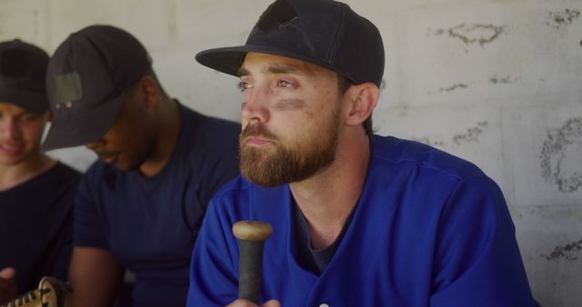 Professional or amateur baseball players resting in the dugout. Ideal for use in sports magazines, athletic-themed websites, or vector artwork highlighting the emotional and reflective aspects of competitive sports.