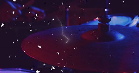 Drum cymbal illuminated in electric stage lighting with starry effects