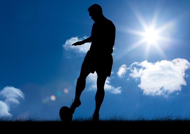 Silhouette of man playing football against sunny sky
