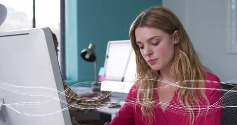 Woman Analyzing Data in Modern Office with Digital Wave Interface