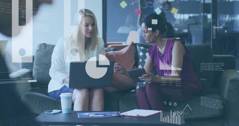 Businesswomen Analyzing Financial Data in Modern Office Collaboration