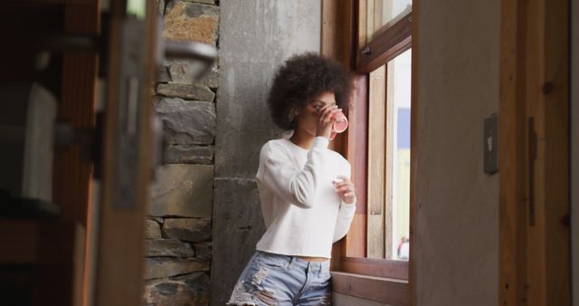 Young Woman Drinking Coffee by Window in Rustic Home - Download Free Stock Images Pikwizard.com