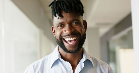 Confident smiling man in office environment
