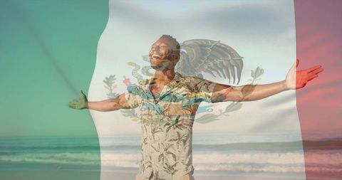 Celebrating joy with mexican flag at sunrise on tropical beach, smiling man with open arms