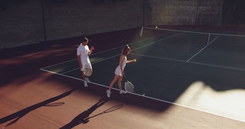 Young Adults Engaging Energetically on Sunlit Tennis Court - Download Free Stock Images Pikwizard.com