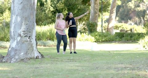 Diverse Female Friends Enjoying Outdoor Fitness in Lush Park