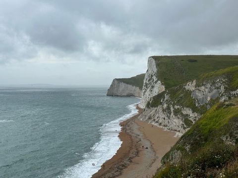 Dramatic coastal cliff beach scene with seaside horizon