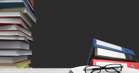 Glasses with Stacks of Books and Folders on Desk Background