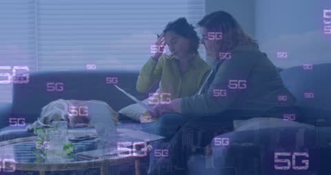 Couple Working on Laptop with 5G Infographic Overlay