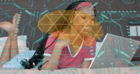 Smiling woman watching laptop with tech circuit overlay for remote learning