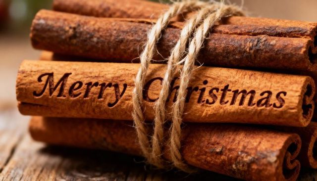 Merry christmas engraved on cinnamon sticks tied with jute twine