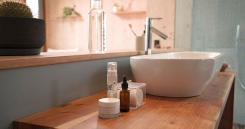Minimalist bathroom vanity with vessel sink and toiletries