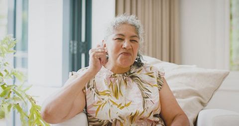 Elderly woman showing wisdom and joy in her living room