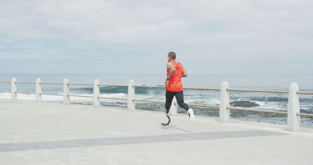 Adaptive Athlete Running Along Oceanfront Path on Overcast Day - Download Free Stock Images Pikwizard.com