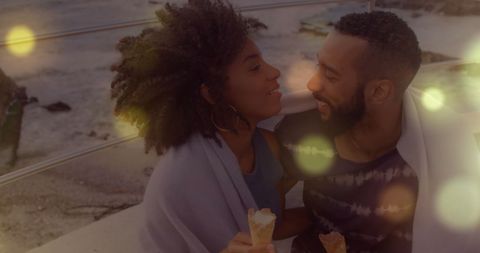 Romantic Couple Enjoying Ice Cream in Illuminated Setting