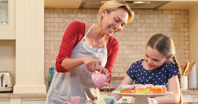 Mother and Young Daughter Baking Decorative Cupcakes Together in Kitchen - Download Free Stock Images Pikwizard.com