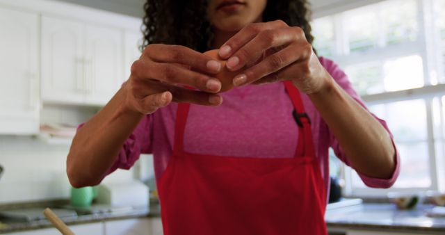 Close-Up of Woman Cracking Egg in Kitchen - Download Free Stock Images Pikwizard.com