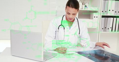 Doctor analyzing x-ray with digital interface in hospital