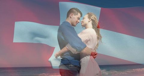 Couple embracing on beach with danish flag double exposure, romantic seaside portrait