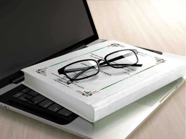 Closed laptop with textbook and eyeglasses on top - Download Free Stock Photos Pikwizard.com