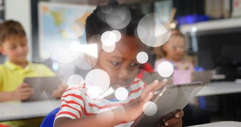 Elementary student tapping tablet for digital learning in colorful classroom environment