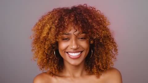 Confident Smiling Model With Elegant Curly Hair in Studio