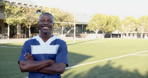 Confident Athlete Portrait on Soccer Field on Sunny Day
