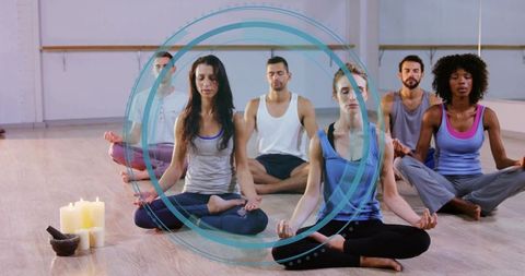 Group meditation class practicing mindfulness and breathwork in bright yoga studio
