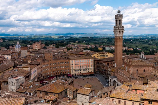 Panoramic View of Siena's Historic Cityscape with Tower under Blue Sky - Download Free Stock Photos Pikwizard.com
