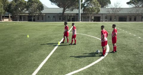 Young Soccer Players Practicing on School Field
