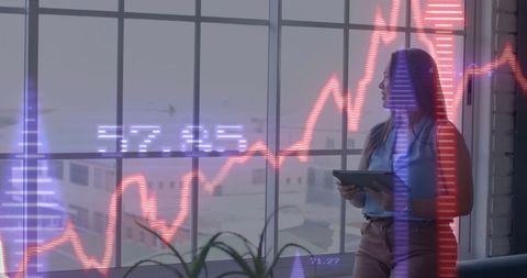 Businesswoman analyzing financial projections with digital data overlay