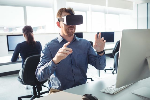 This image shows a mature student in a college setting using a VR headset, immersing in an interactive learning experience. Could be used for topics related to adult education, innovative teaching methods, technology in the classroom, or lifelong learning. Ideal for educational websites, technology blogs, and promotional materials for academic institutions.