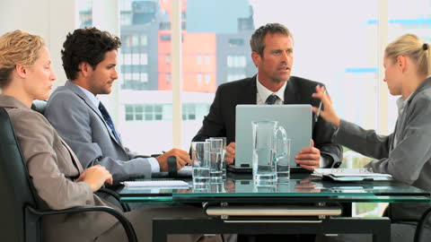 Diverse Team Engaged in Intense Office Meeting