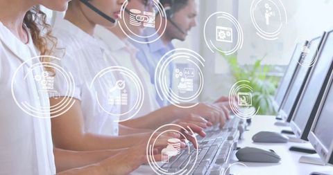 Customer Service Team Using Headsets and Computers in Modern Office