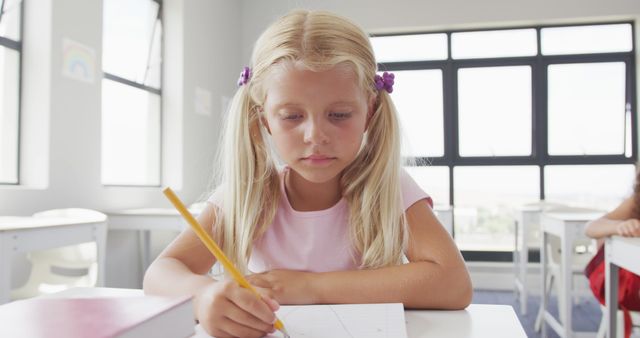 Young Girl Concentrating on Drawing in Classroom - Download Free Stock Images Pikwizard.com