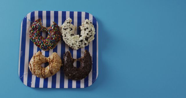 Colorful Donuts with Toppings on Blue and White Plate - Download Free Stock Images Pikwizard.com