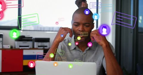 Overwhelmed man with message notifications surrounding laptop