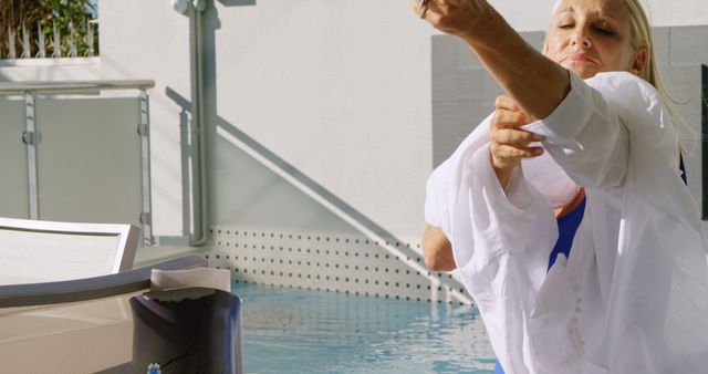 Senior Woman Preparing for Outdoor Swimming by the Pool - Download Free Stock Images Pikwizard.com