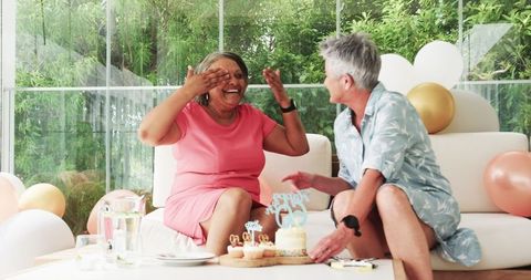 Seniors Celebrating with Birthday Cake Indoors