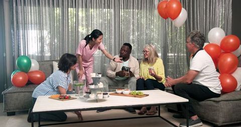 Multicultural Physiotherapy Patients Celebrating in Treatment Center