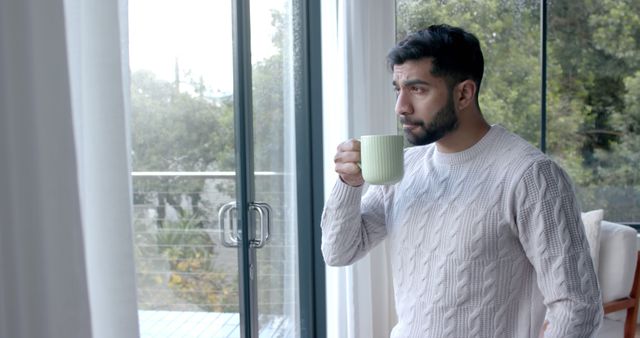 Young Man Drinking Coffee by Window in Cozy Home - Download Free Stock Images Pikwizard.com