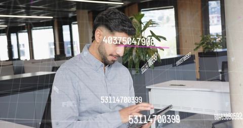 Man Reviewing Digital Data Interactions in Modern Office