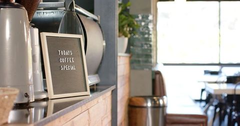 Letter board displaying today's coffee special on rustic cafe counter in daylight