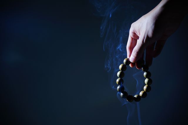 Hand Holding Prayer Beads with Rising Smoke in Dark Background - Download Free Stock Photos Pikwizard.com